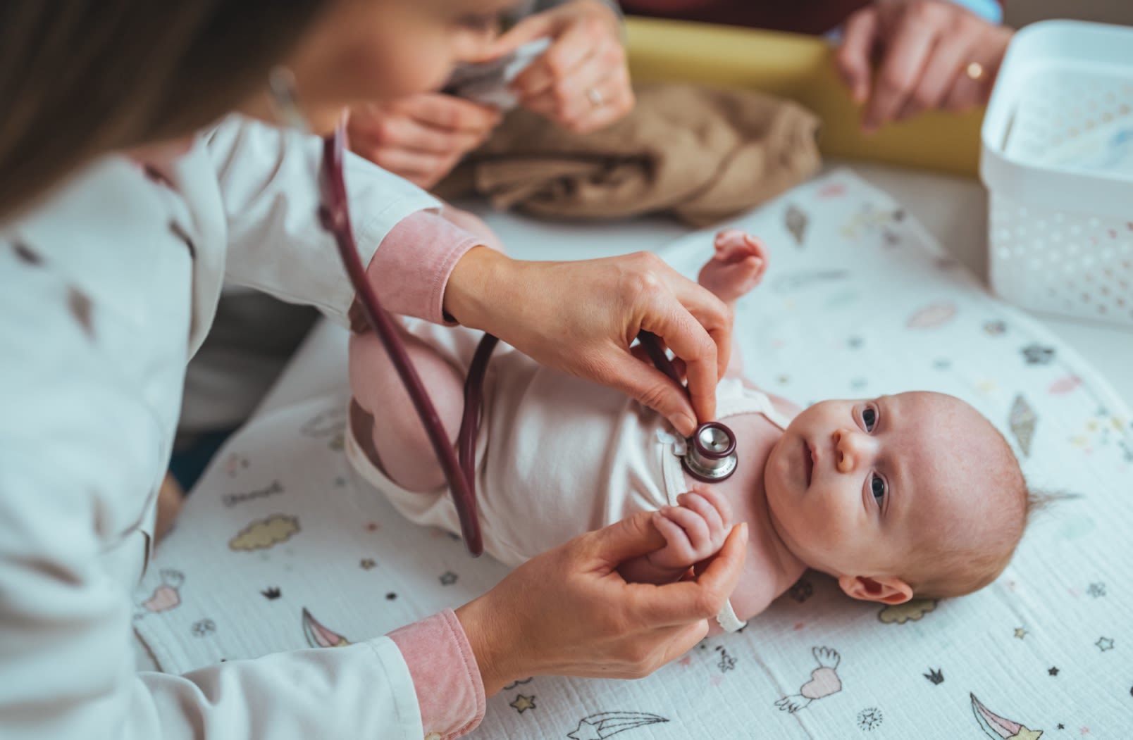 baby covered with white blanket